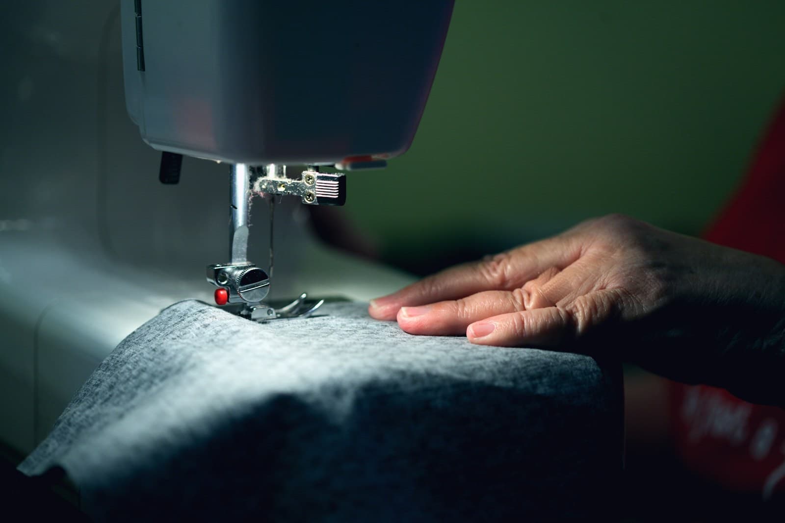 Heavy canvas being guided through an industrial sewing machine