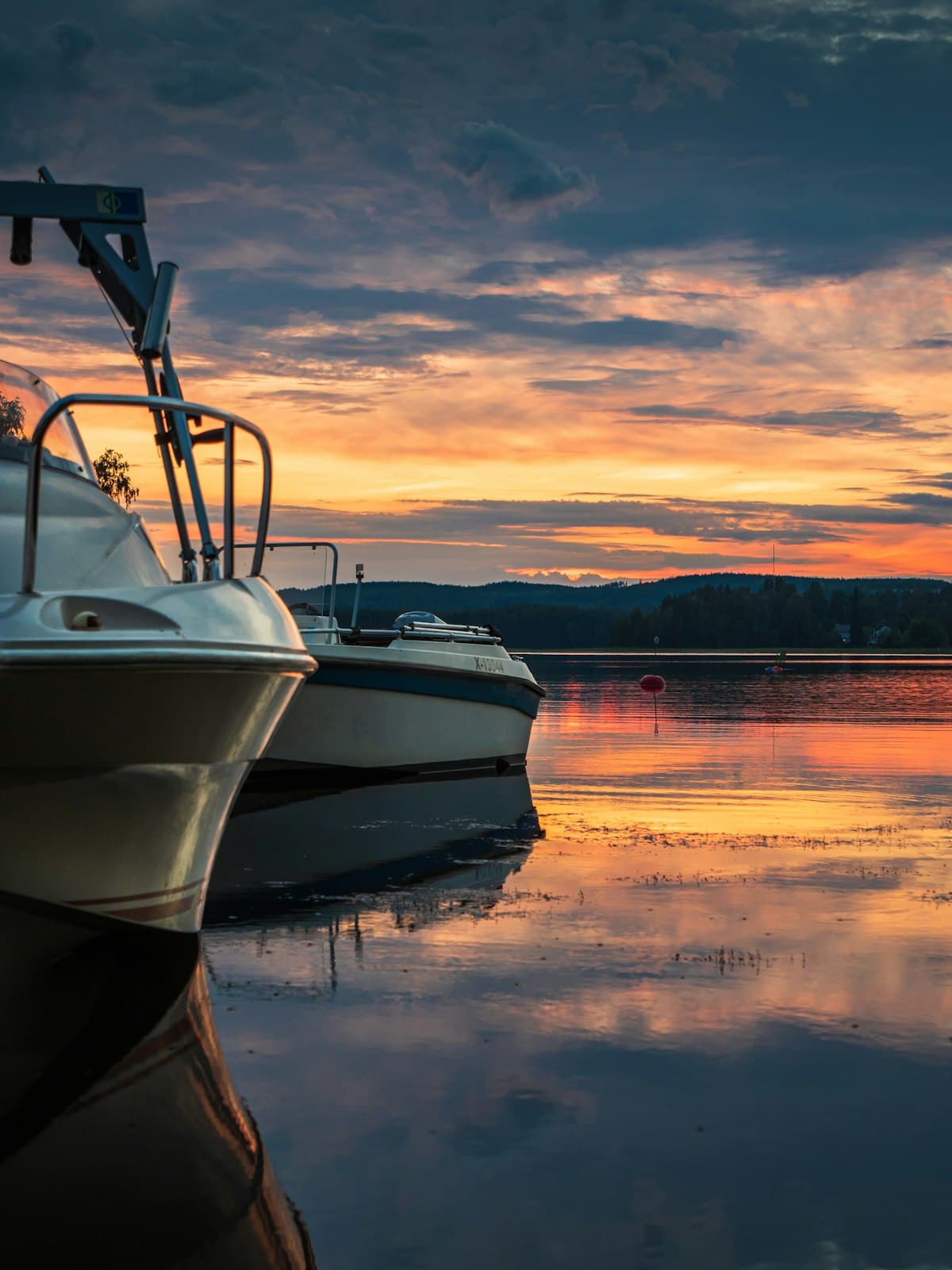 Boats resting on a calm lake at sunset